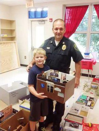 Camden Police Officer Mike Stone and 2nd Grader Cade Marturano holding a replica of the Camden Police Department - Web