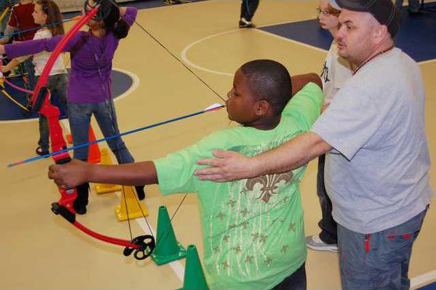 Miller shows student how to shoot.JPG